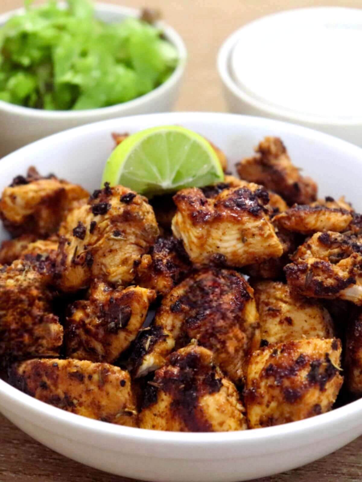 close-up of cajun chicken bites served in a bowl.