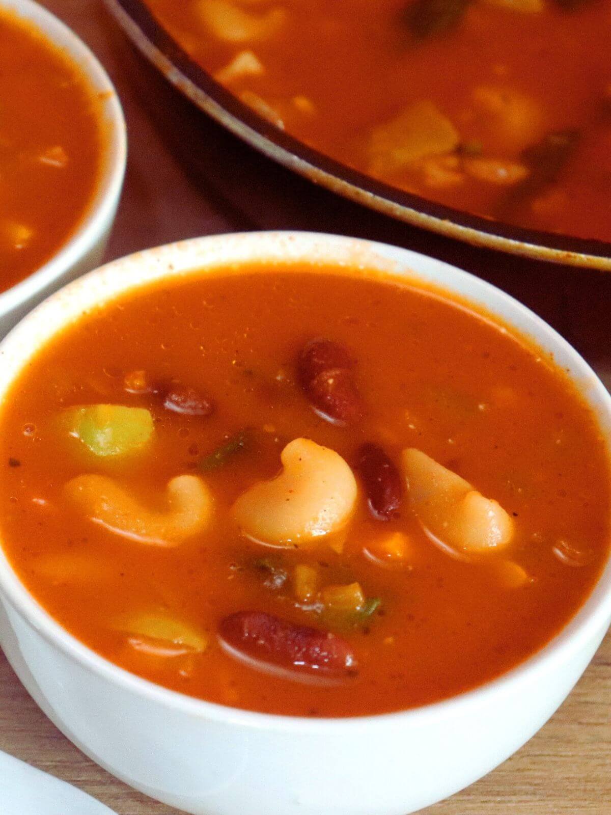 close-up of vegetarian minestrone soup served in a bowl.
