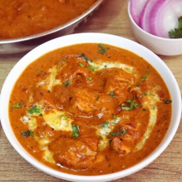 restaurant style chicken tikka masala served in a white color bowl.