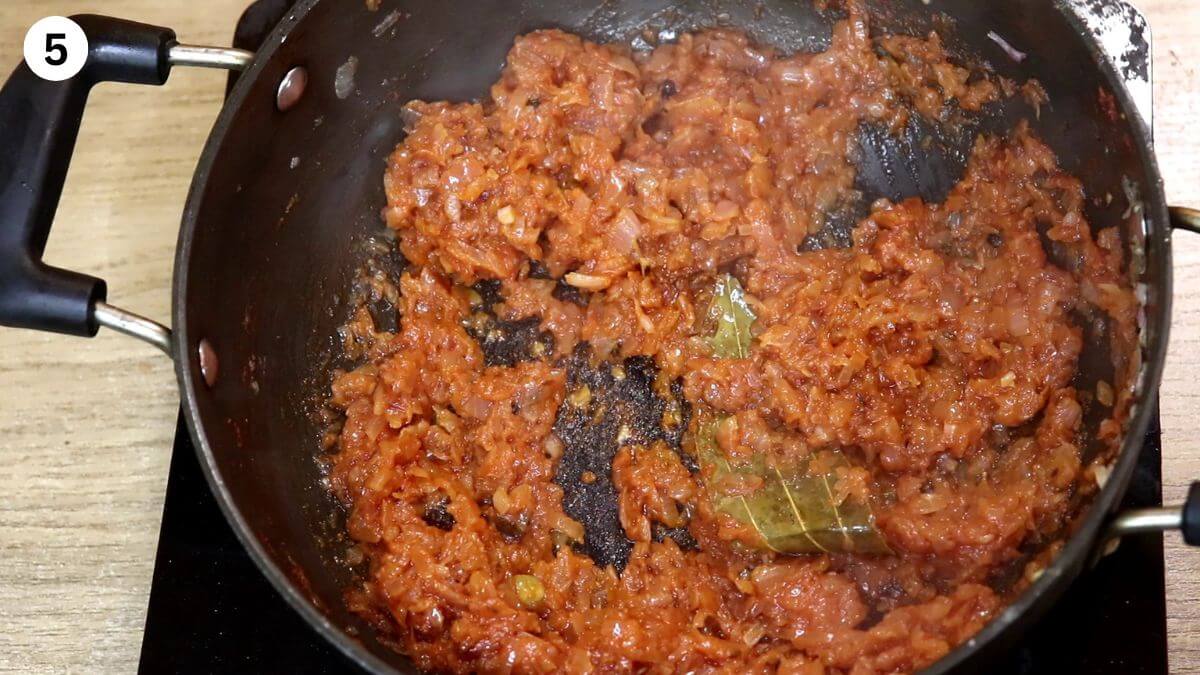 Addition and cooking the tomato paste for dopiaza curry.