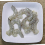 clean and deveined prawns in a white plate.
