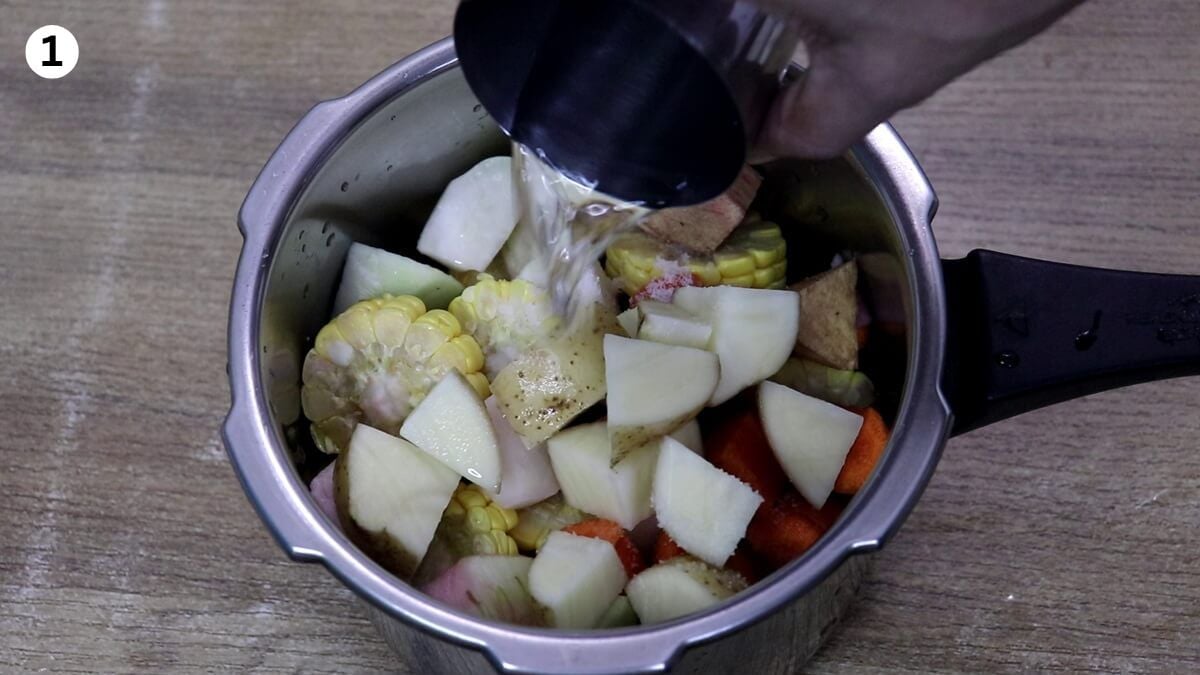 Cooking mixed seasonal vegetables for Goan Khatkhate in a pressure cooker.