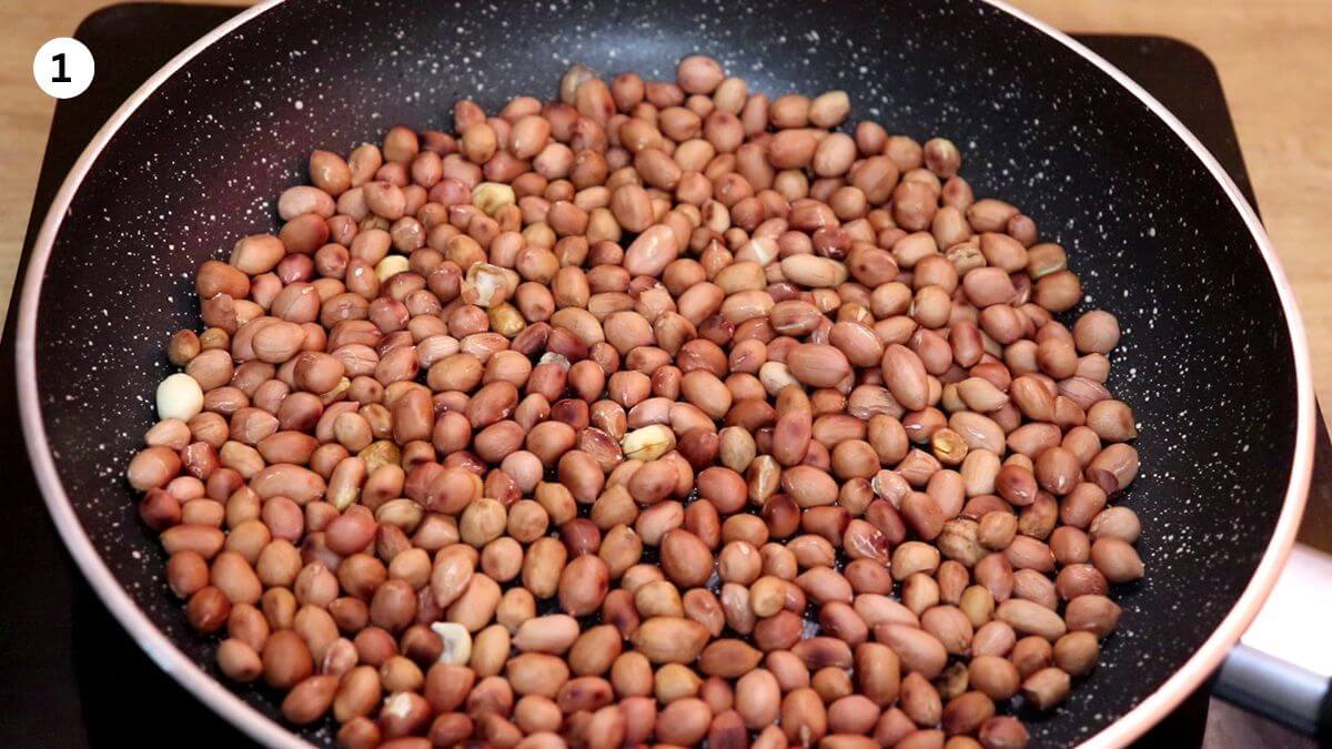 roasting peanuts in a pan until black spots appear.