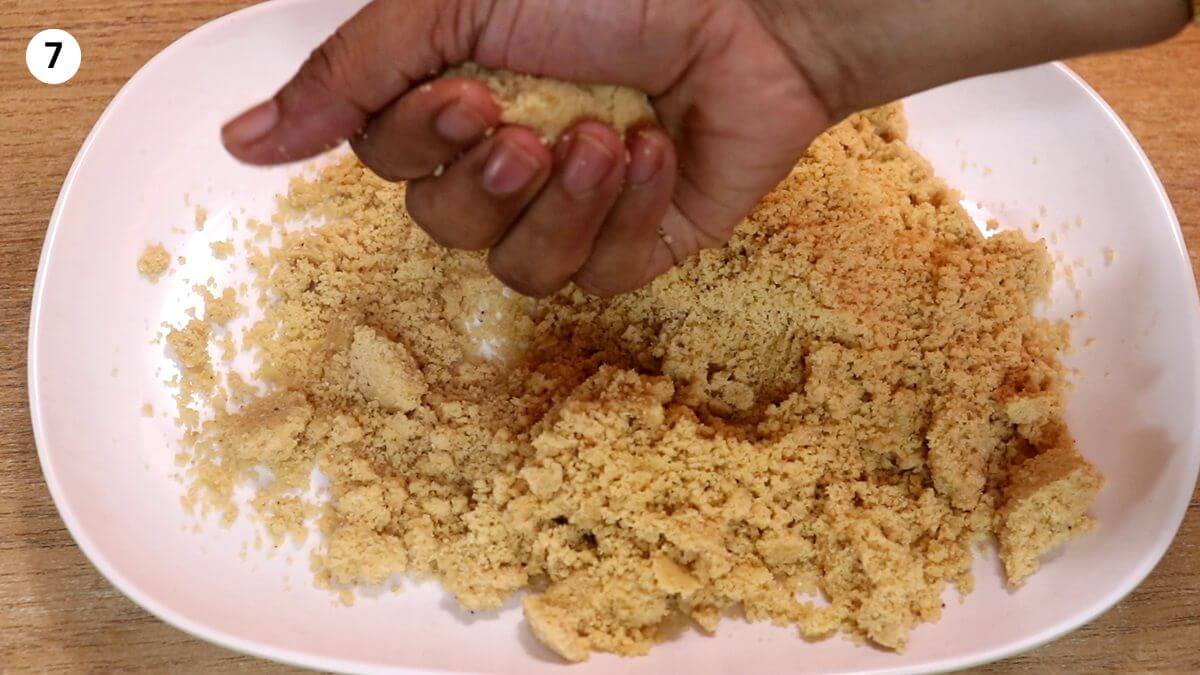 rolling the peanut jaggery mixture into ladoos.
