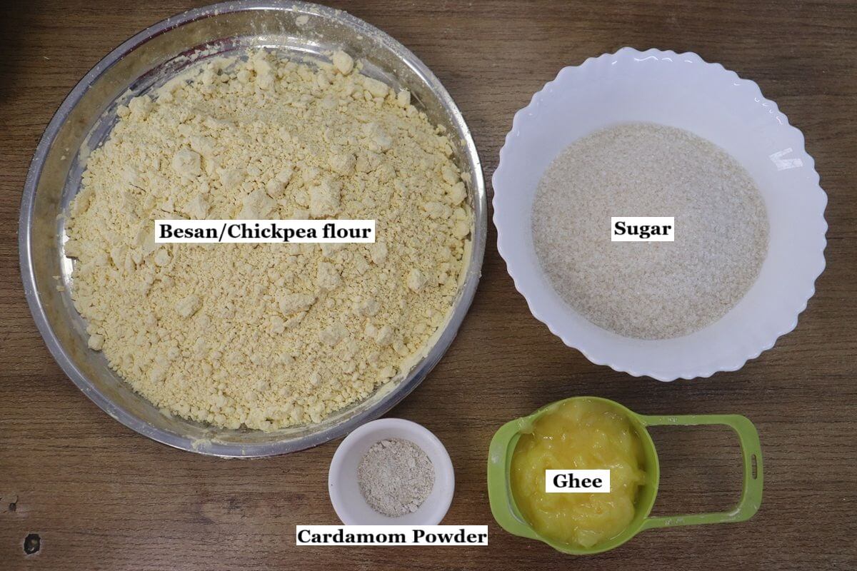 individually labelled ingredients to make besan burfi recipe are laid out on a table.