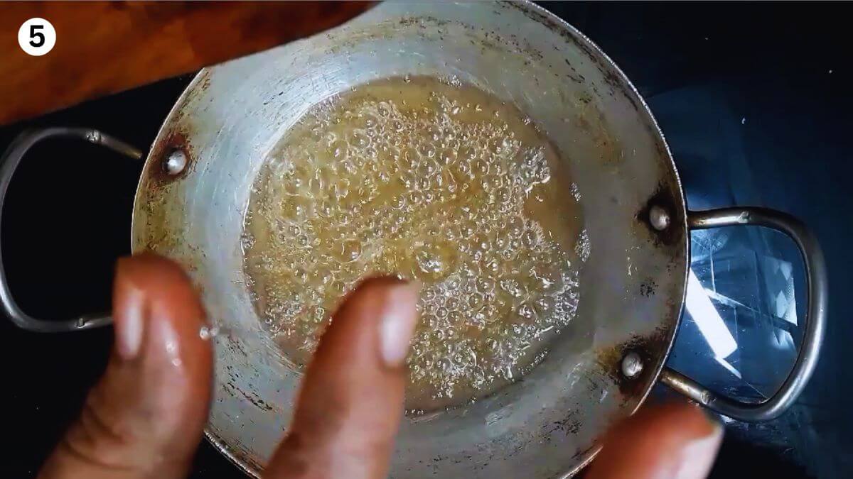 checking the sugar syrup for one string consistency.