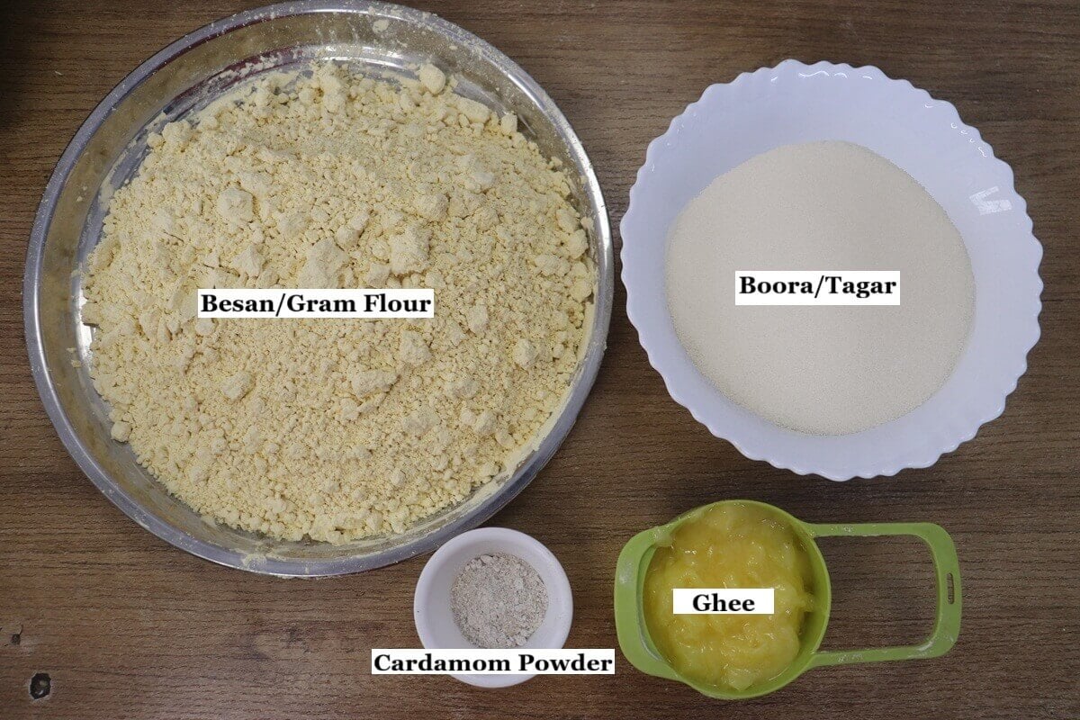 individually labeled ingredients to make besan ladoo recipe are laid out on a table.