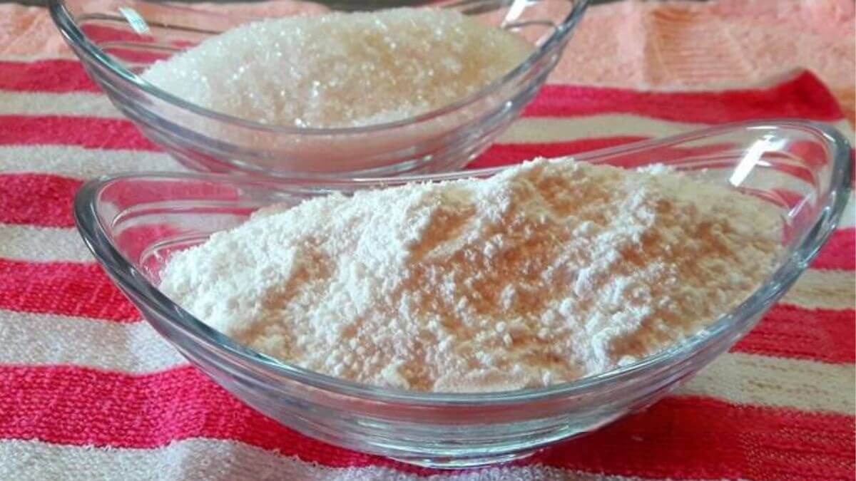 Boora in a bowl with another bowl of plain sugar placed beside it.
