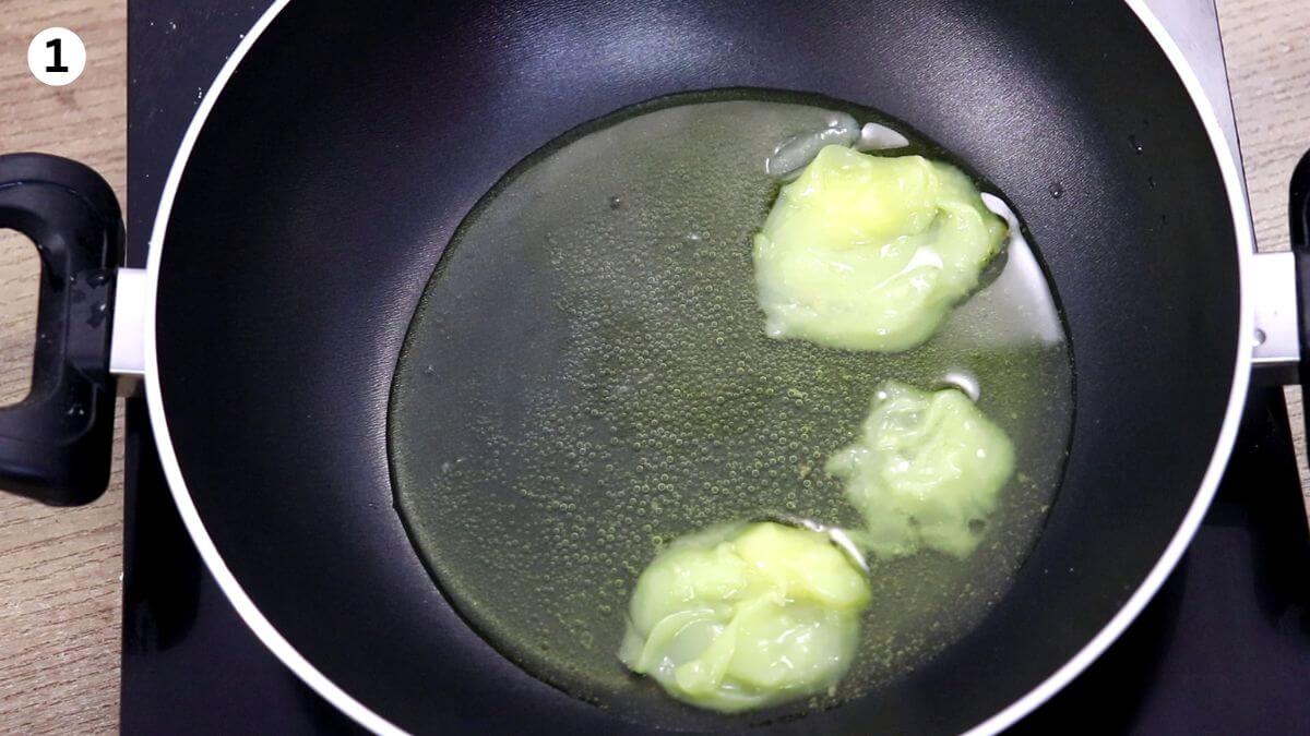 melting ghee in a pan to make danedar besan ladoo.