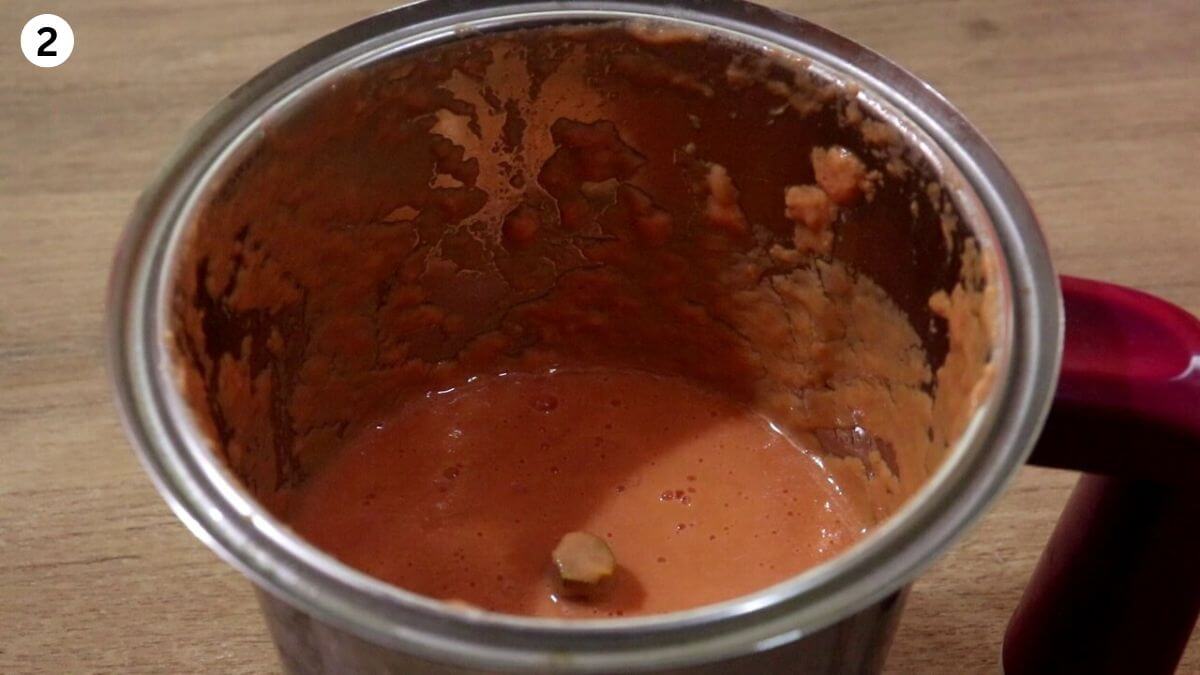 making cashew tomato paste for garlic chicken curry recipe.