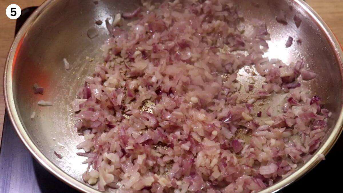 sauteing onions to make garlic chicken curry.