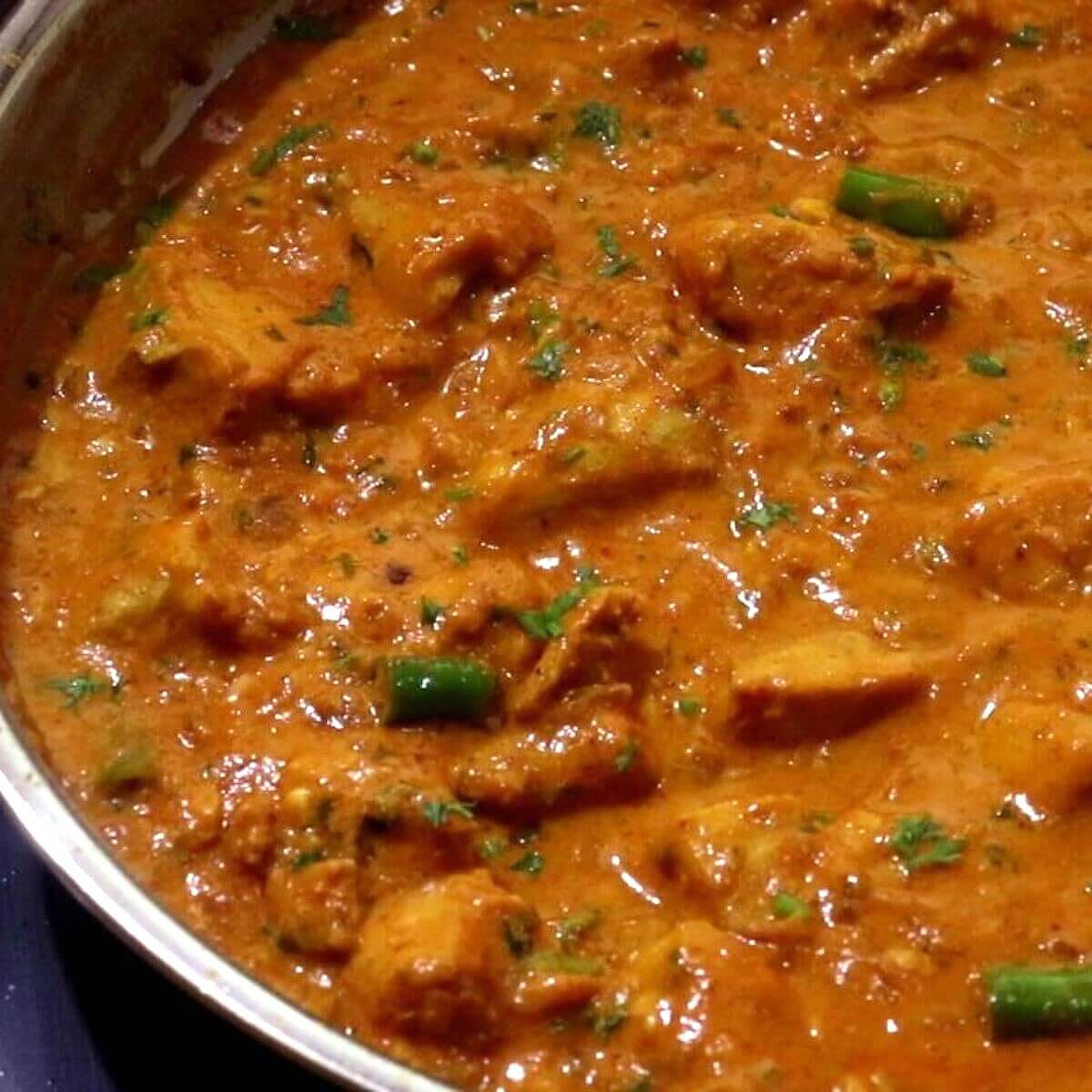garlic chicken curry in a skillet.