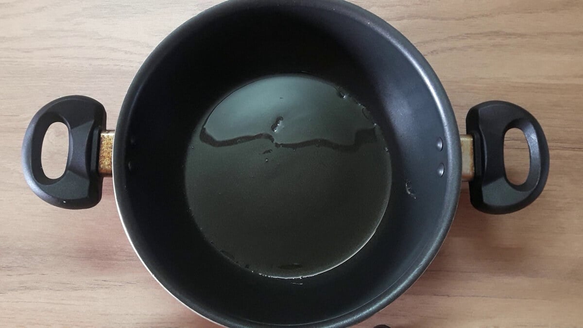coating the pan with ghee to make instant mawa recipe.