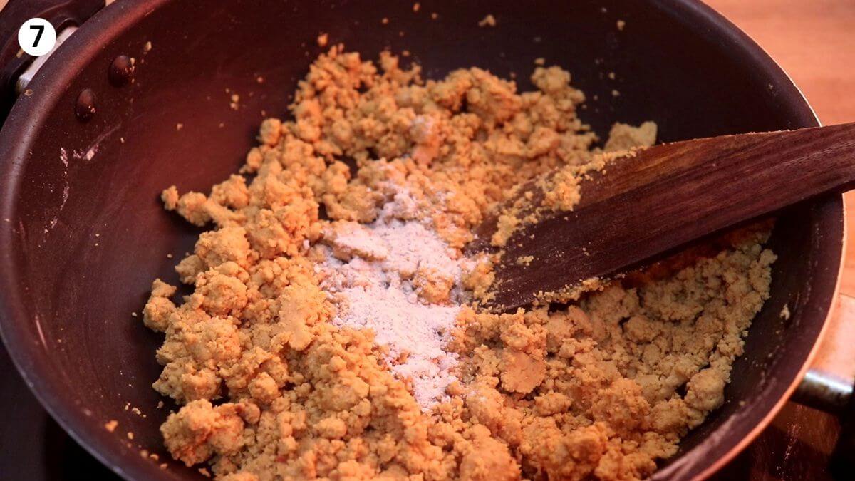 addition of cardamom powder to roasted moong dal powder to make ladoo.