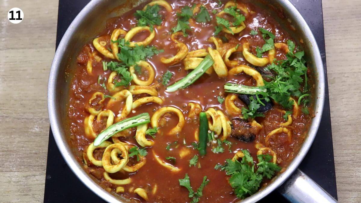 addition of green chilies, coriander leaves and lemon juice to squid masala.