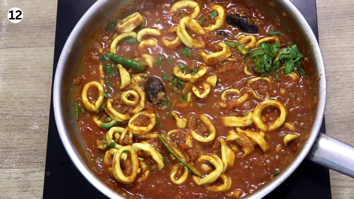 cooked squid masala in a pan.