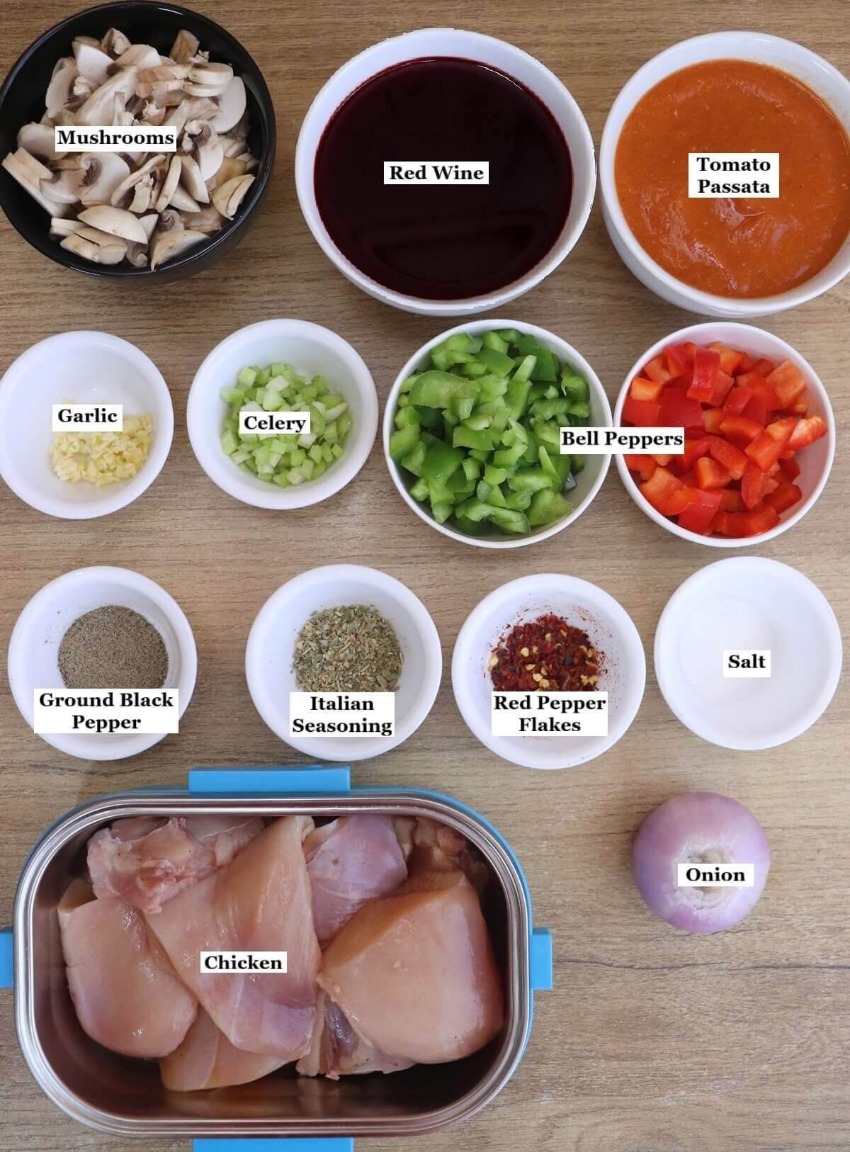 individually labelled ingredients to make chicken cacciatore are laid out on a table.