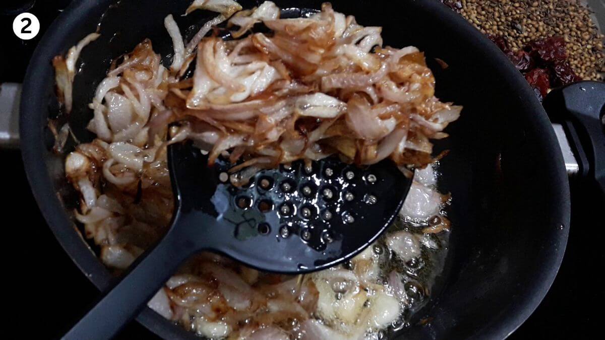 frying onions to make hyderabadi chicken masala curry.