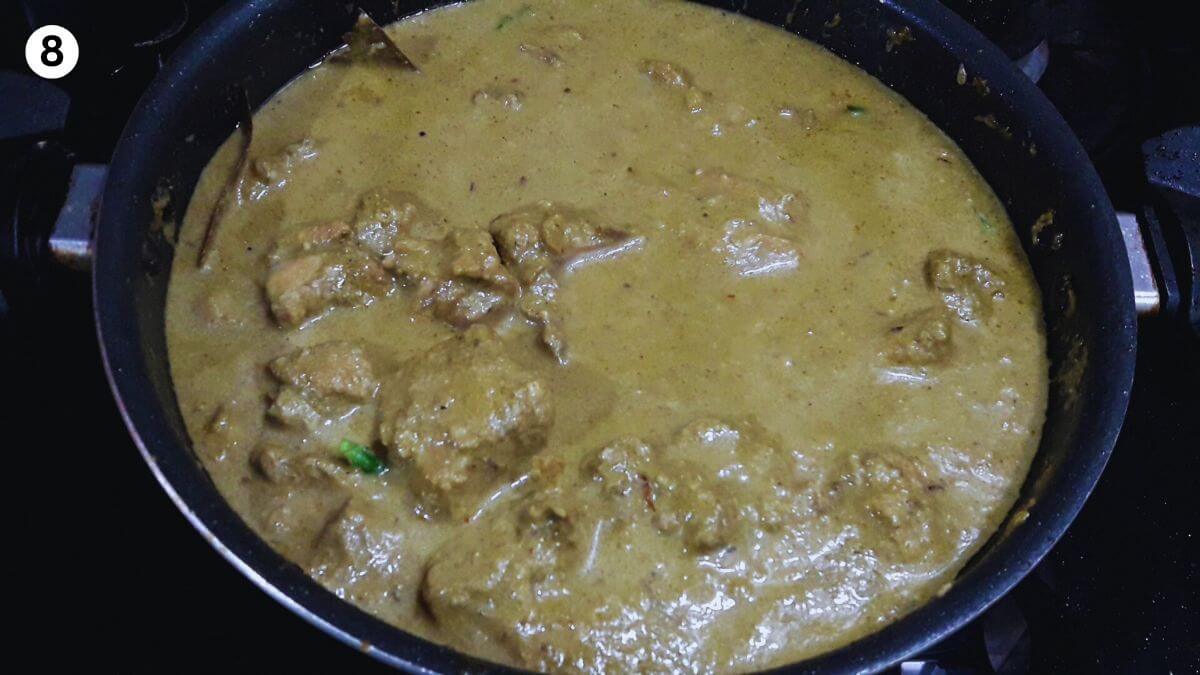 cooked hyderabadi green chicken curry also called hariyali chicken in a pan.