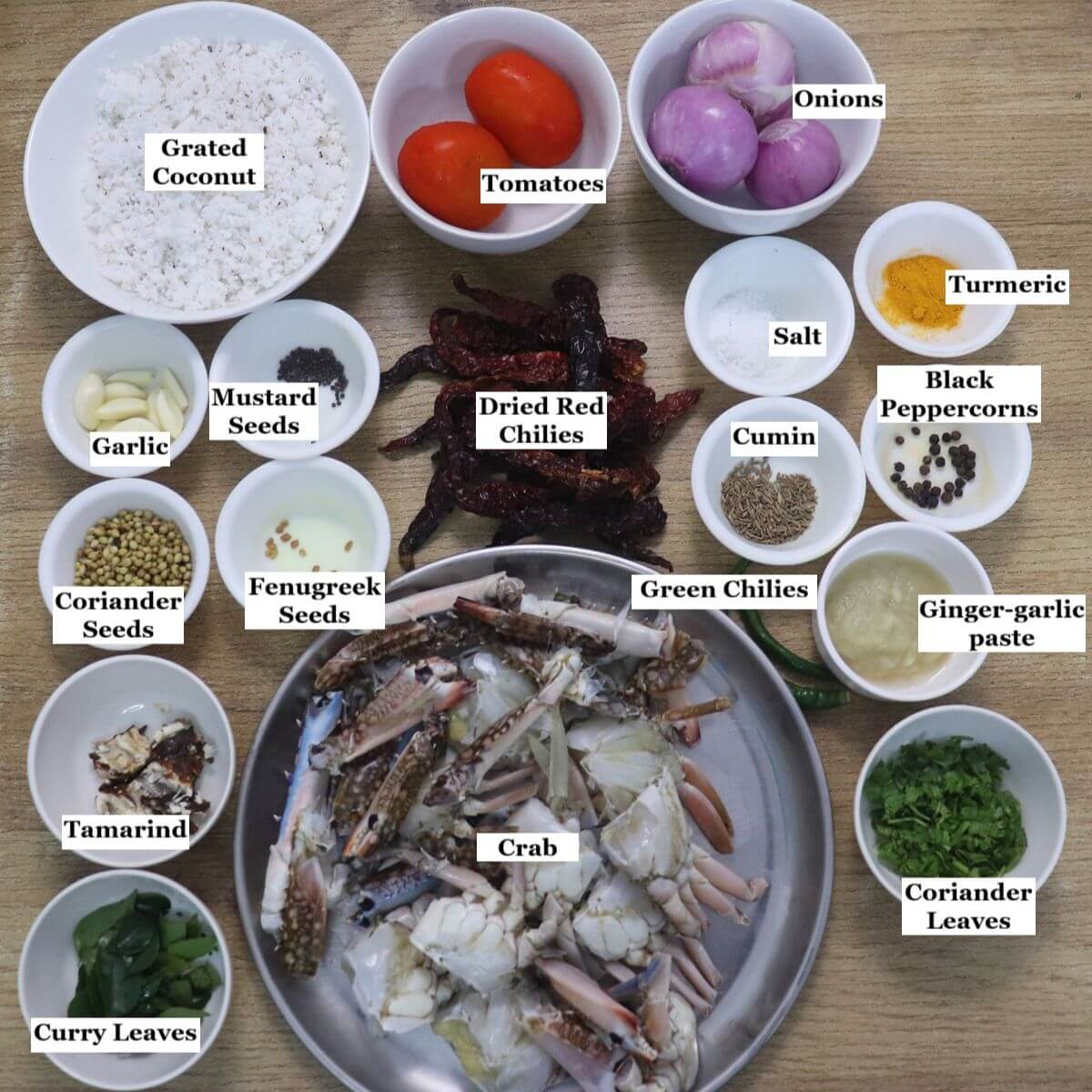 individually labelled ingredients to make mangalorean crab sukka are laid out on a table.
