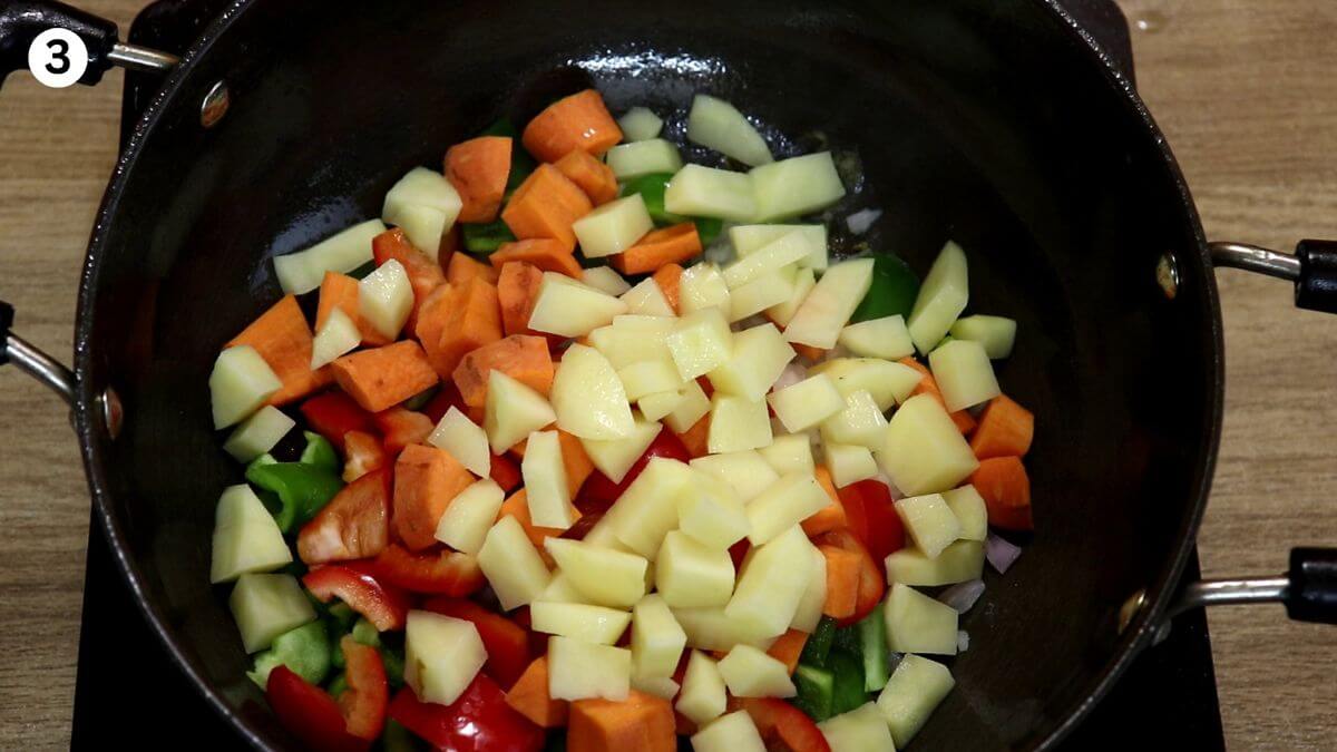addition of vegetables to the pot to make one pot chicken stew.