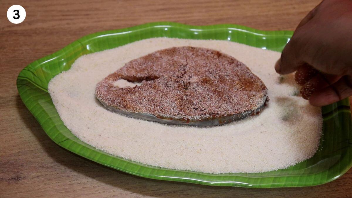 coating the marinated fish with rava.