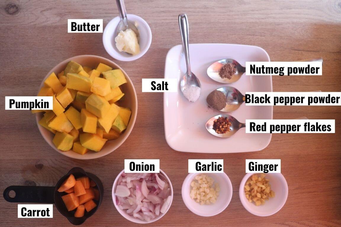 individually labelled ingredients to make roasted pumpkin soup recipe are laid out on a table.