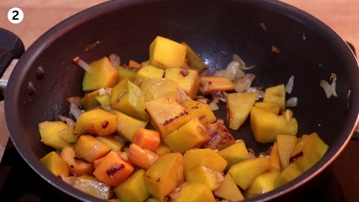 roasting chopped pumpkin and carrots on the stovetop until golden and tender.