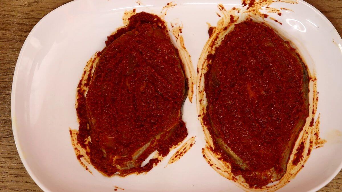 fresh kingfish pieces marinated with homemade masala in a plate.