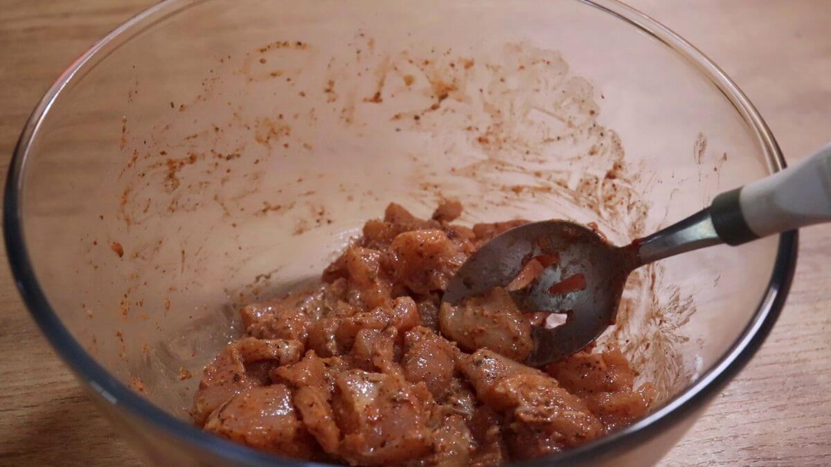 marinated chicken in a bowl for making homemade chicken nuggets.