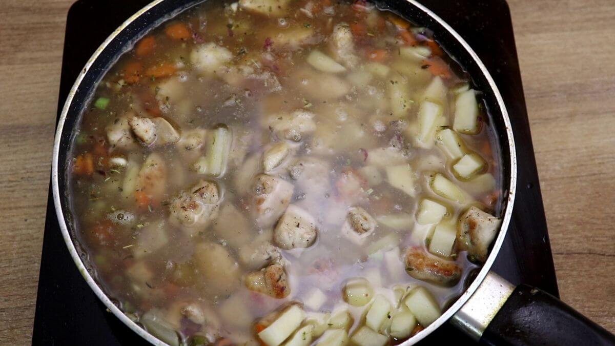 addition of chicken broth to make creamy vegetable chicken stew.