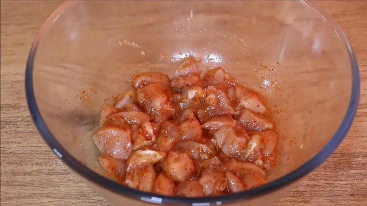 marinating the chicken to make popcorn chicken at home.