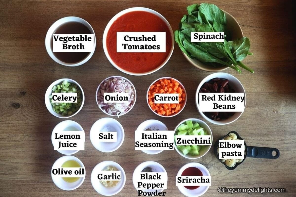 individually labelled ingredients to make Italian minestrone soup recipe are laid out on a table.