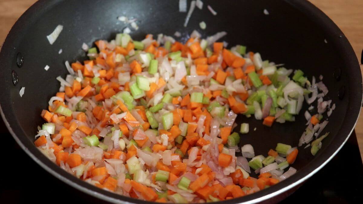 addition of vegetables and cooking them to make italian minestrone soup recipe.