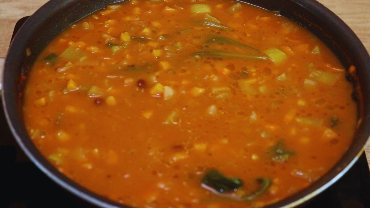cooked minestrone soup in a pan.