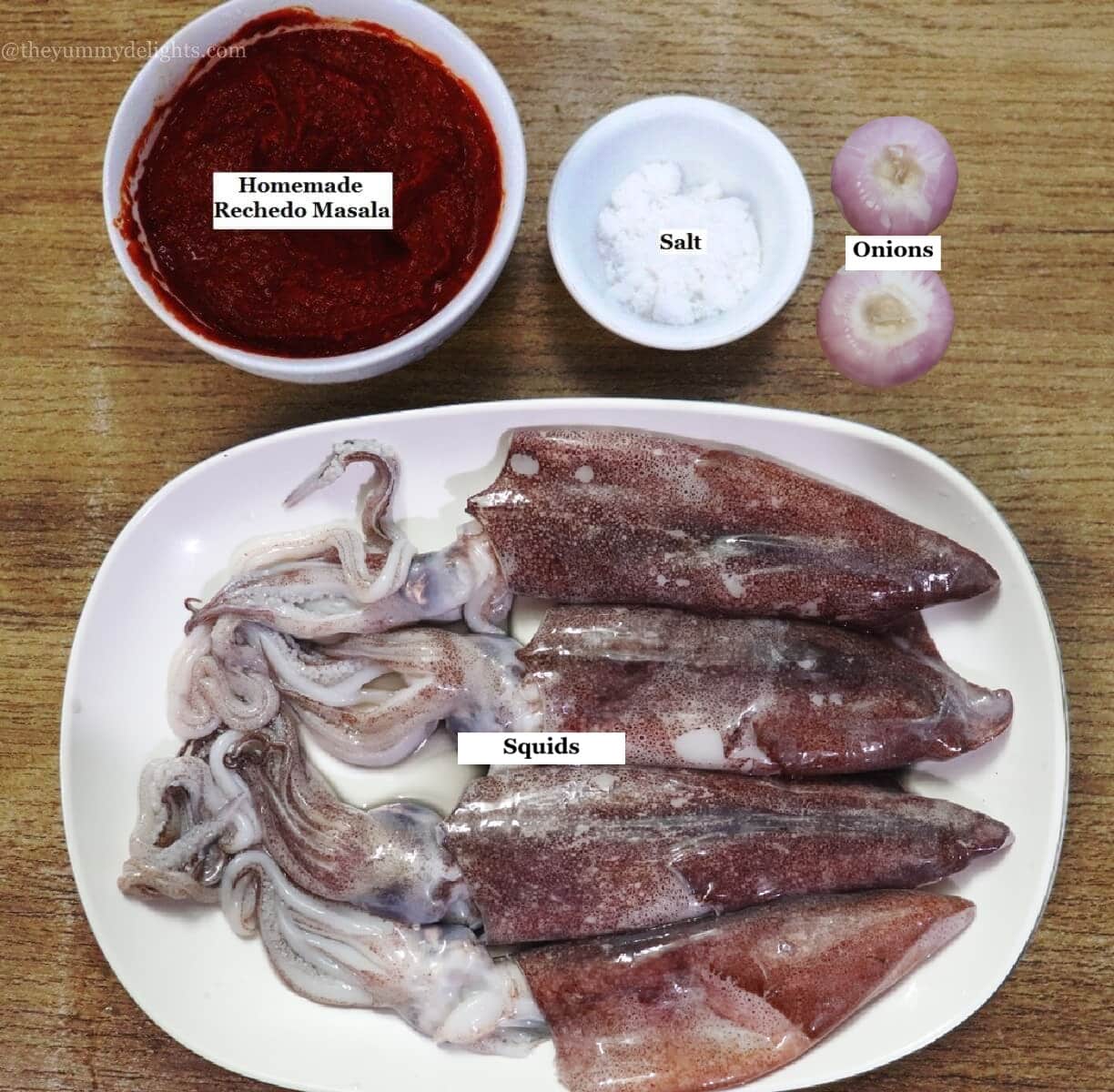 individually labelled ingredients to make stuffed squids recipe are laid out on a table.