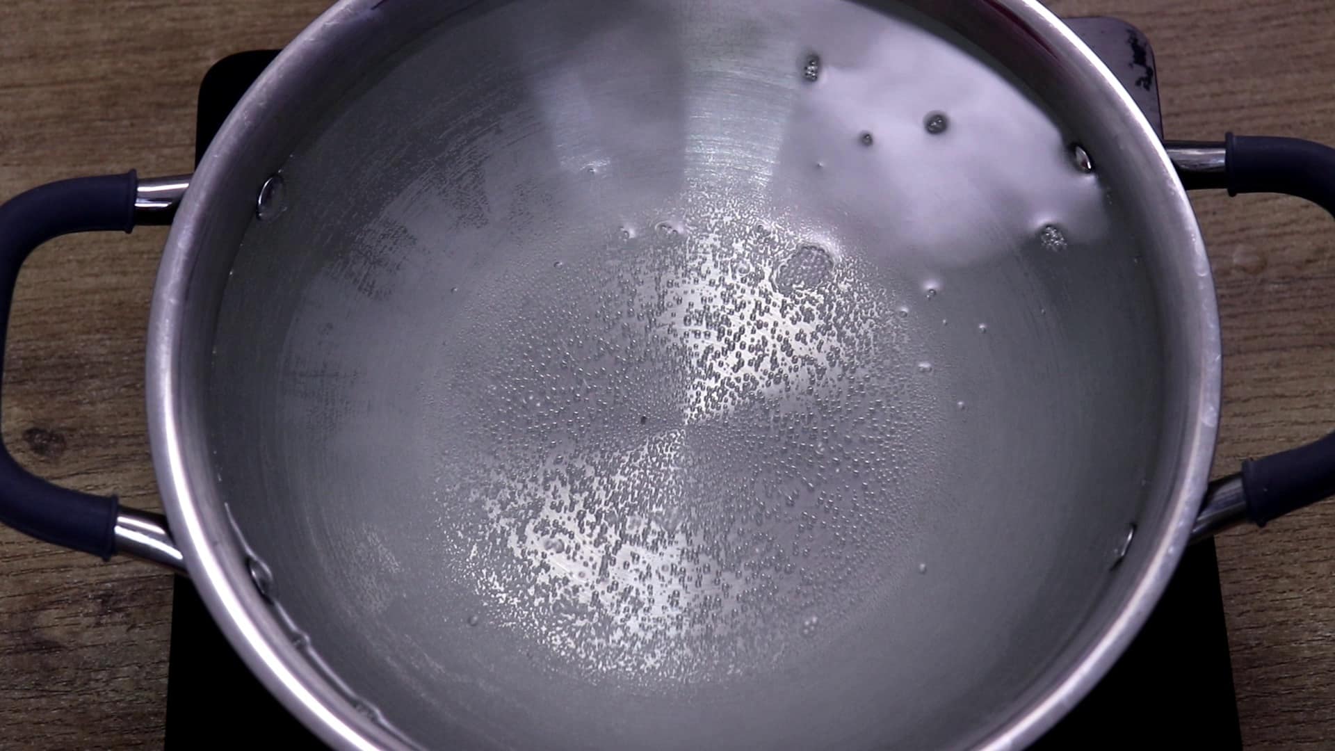 Boiling water to cook chicken for meal prep.