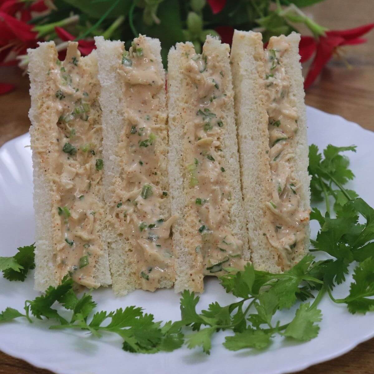 chicken mayo sandwich stacked on a plate.