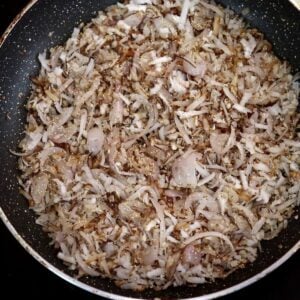 roasting the coconut and whole spices to make goan xacuti masala.