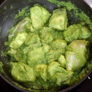 cooking the marinated chicken to make xacuti curry.