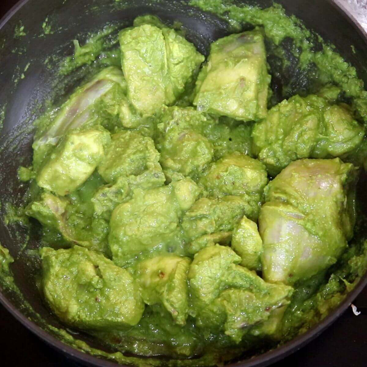 cooking the marinated chicken to make xacuti curry.