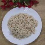 Shredded chicken ready to use for meals kept on a plate.