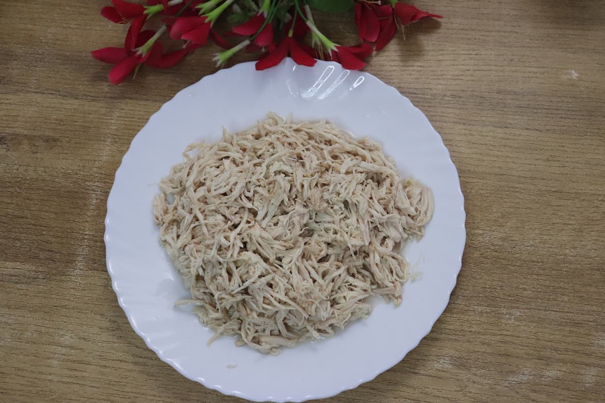 Shredded chicken ready to use for meals kept on a plate.