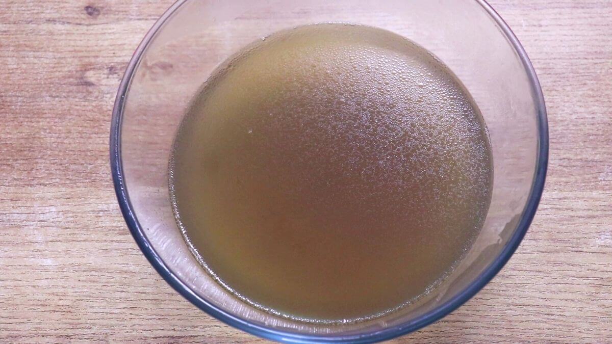 Homemade chicken stock ready to store in bottles.