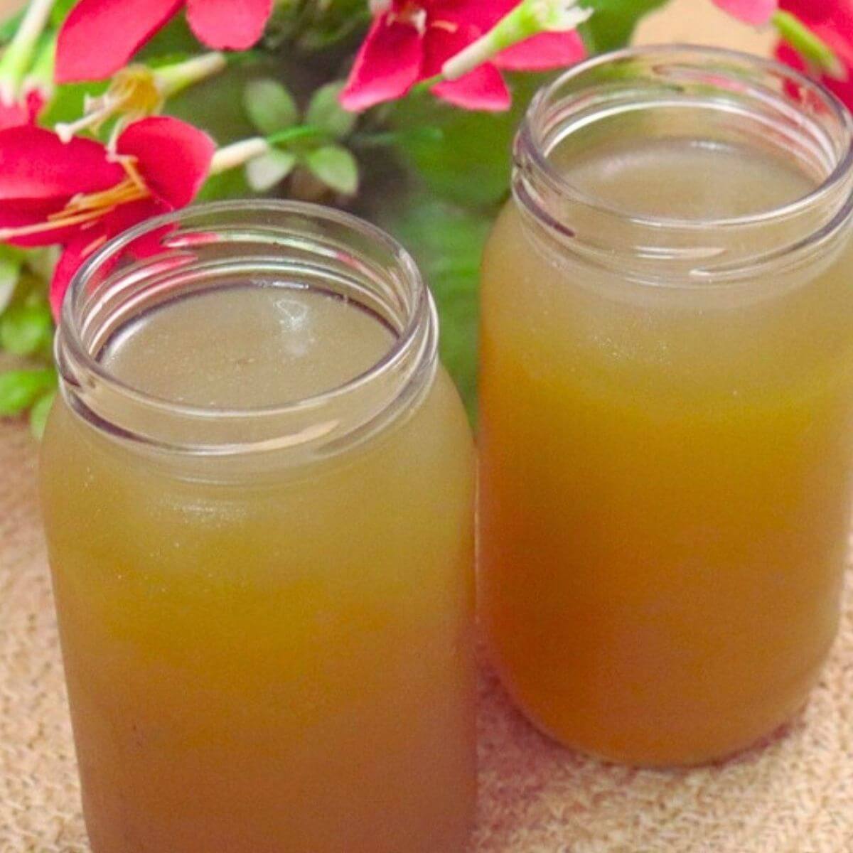 Two bottles of homemade chicken stock cooled and ready to store.
