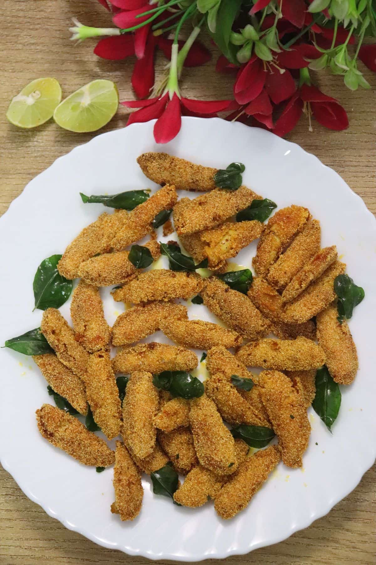 silver fish fry also known as bolenjir fry served with lemon wedges on the side.