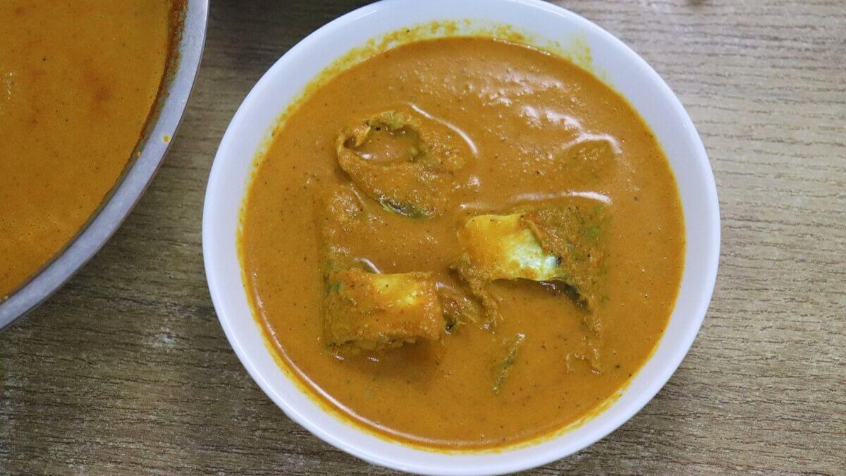 Goan Bangdyachi Uddamethi in white bowl with extra curry in pan.