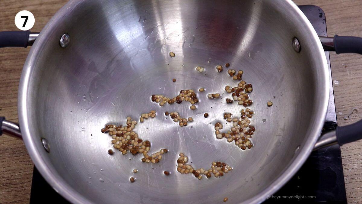 tempering of urad and methi in a pan for bangdyachi uddamethi recipe.