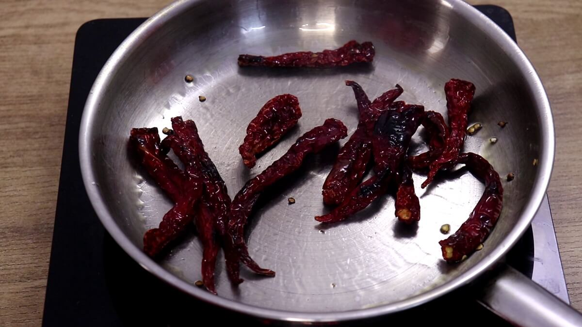 roasting red chillies for making bangda uddamethi recipe.