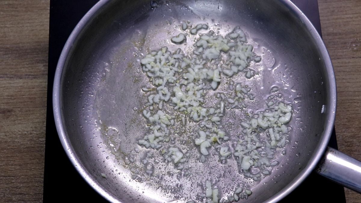 Garlic sauteing in a pan for squid chilli fry.